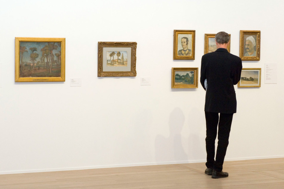 Visitor looking at paintings