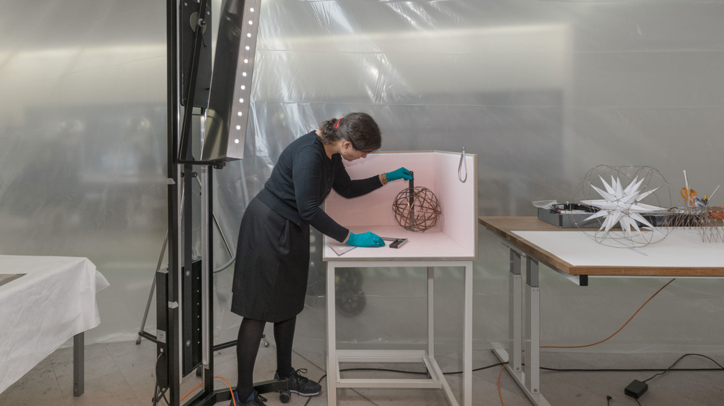 Sculpture conservator, My Bundgaard, measuring one of the models from Model Room