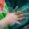 Child hands with mud