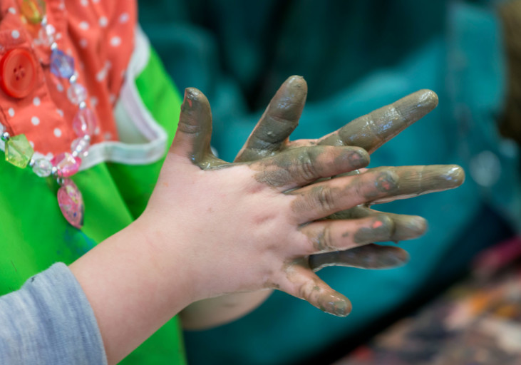 Child hands with mud