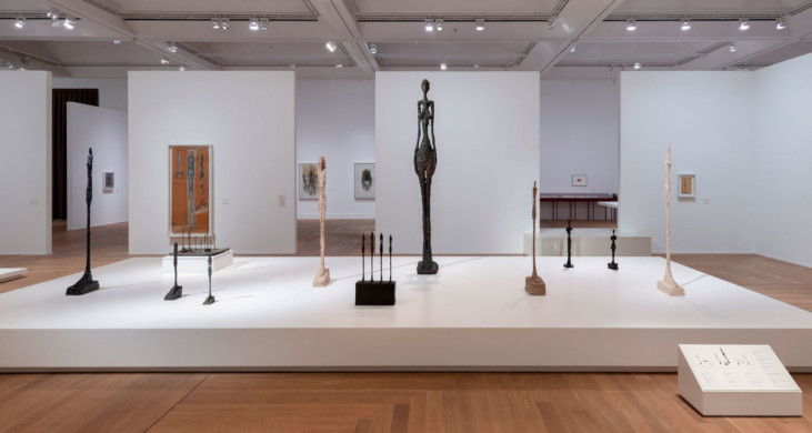 Sculptures on a podium in a museum hall.