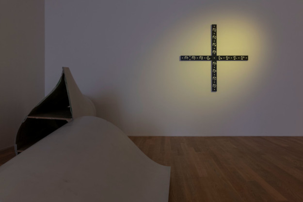 Art Installation in dim room with wooden floors.