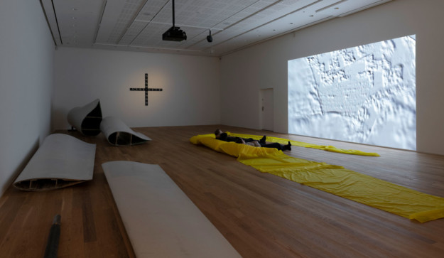 Several works of art in room with wooden floors.