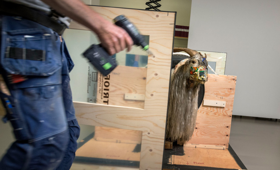 The artwork Monogram, with a stuffed goat, in a work environment.