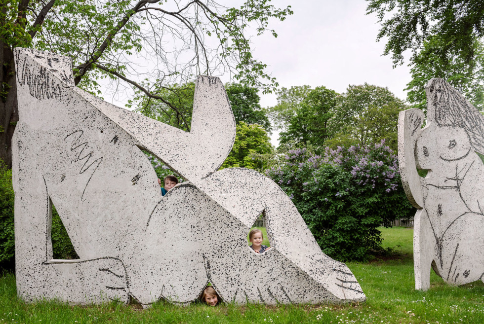 Children behind one of the sculptures in Picasso's group Déjeuner sur l’herbe (Luncheon on the Grass).