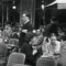 Black and white photograph of a café with guests.