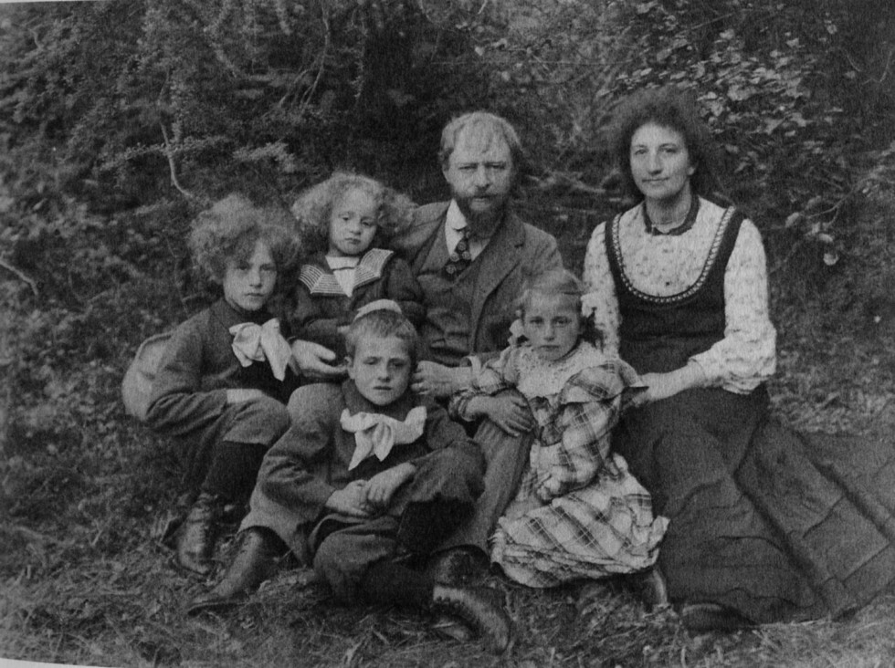 Black and white photograph of the Giacometti family sitting in nature