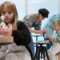 Children sitting on chairs in the workshop creating sculptures in foil and clay.