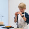 A child creates a sculpture with steel wire and clay