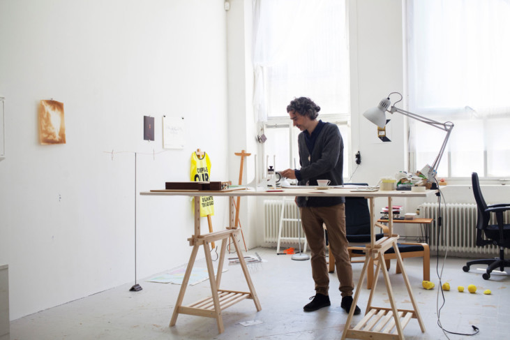 A person standing next to a table in a studio