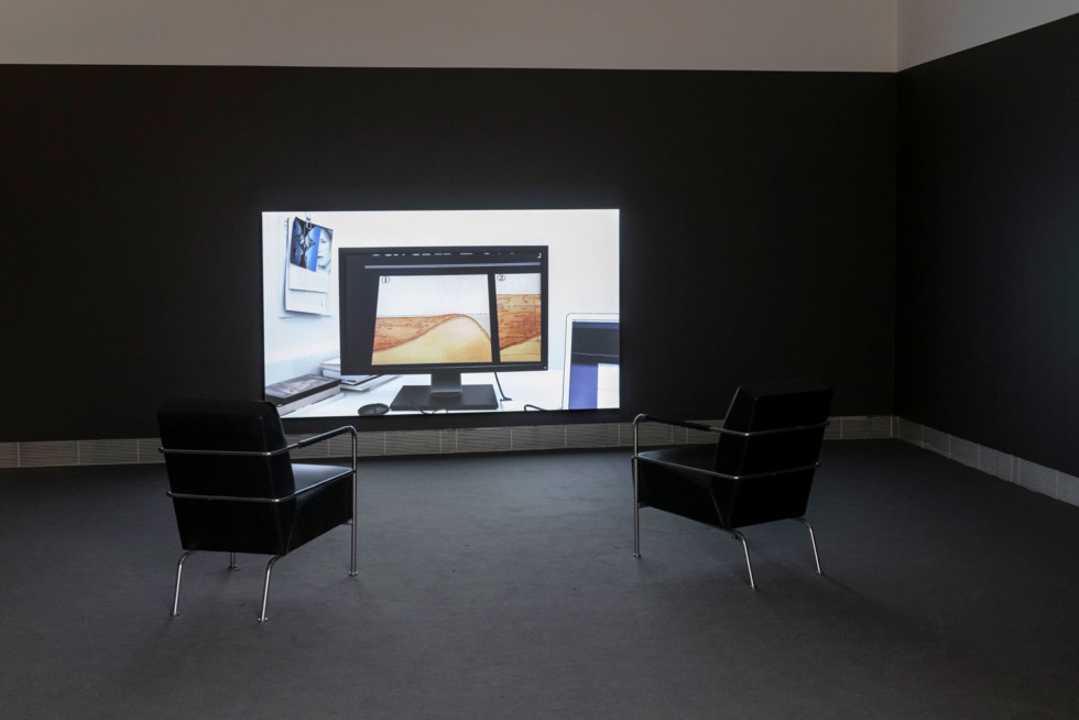 Two chairs in front of a video projection on the wall