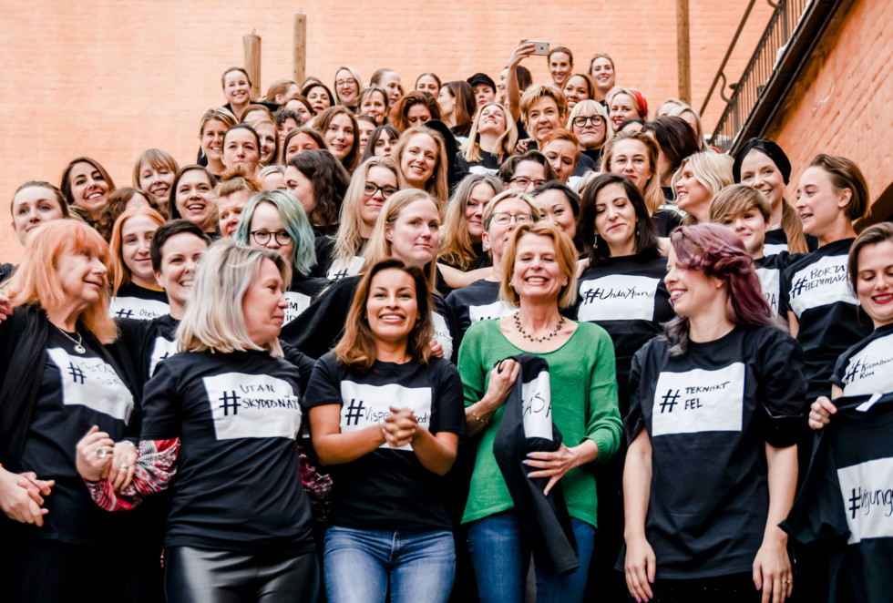 Large group of women on stairs.