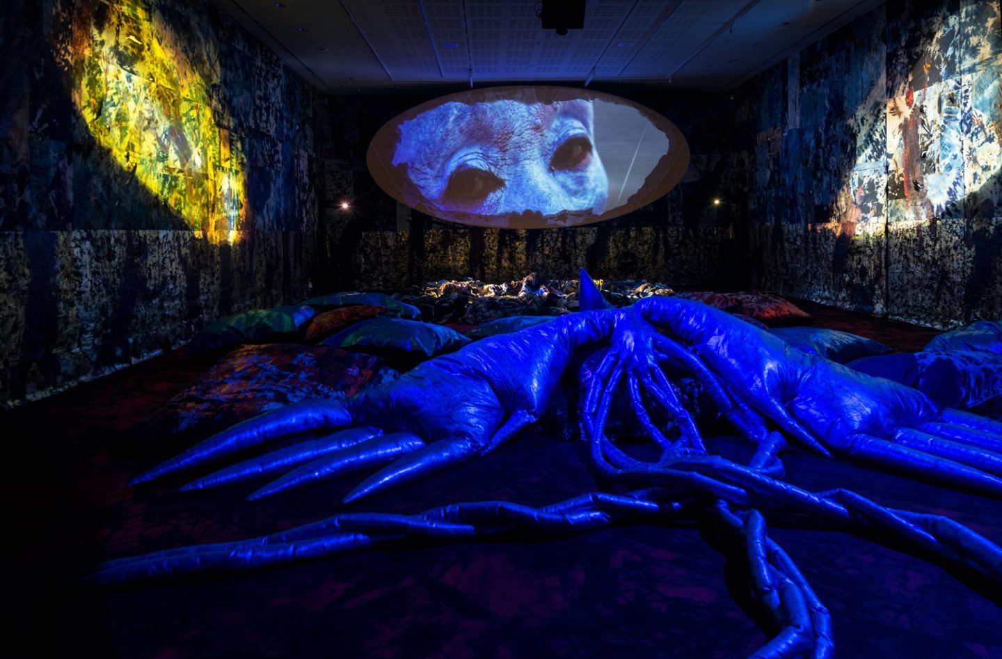 A dark room with projections on the wall