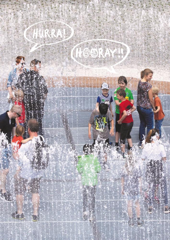 Children and adults play in Jeppe Hein's fountain