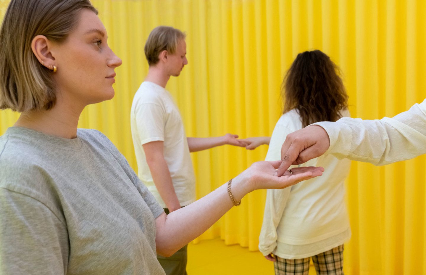 Four people holding hands