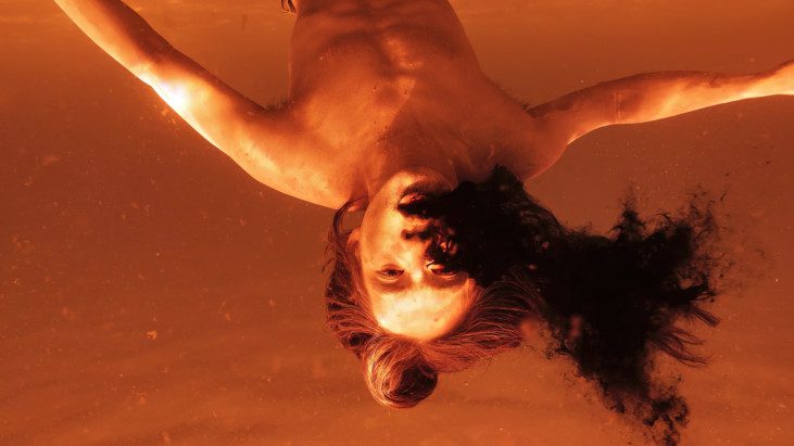 A person underwater upside down