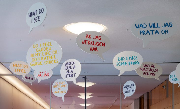 Photo of signs with texts hanging in a ceiling