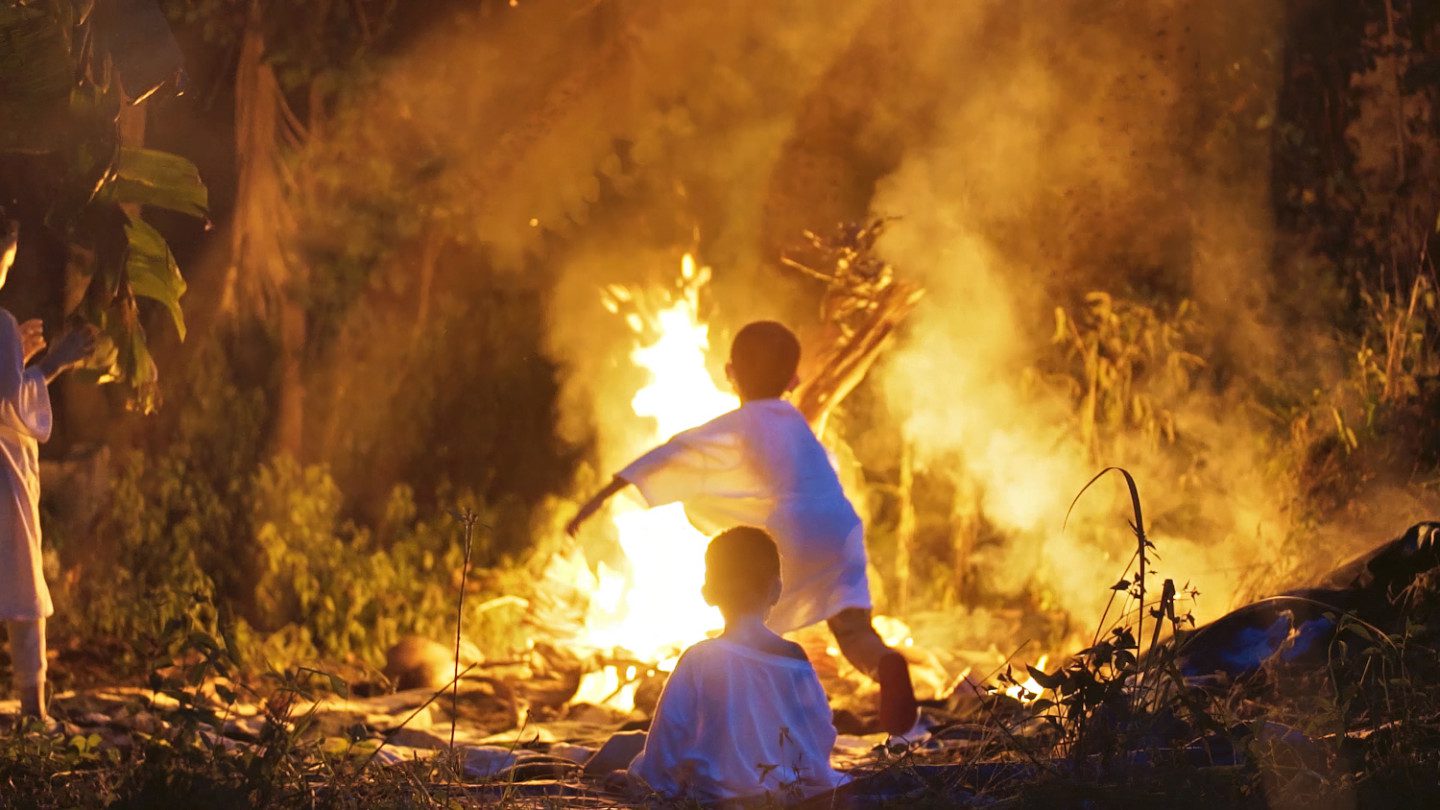 two kids by a fire