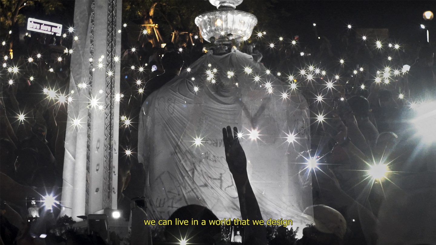 Demonstration in black and white, with a subtitle saying "we can live in a world we design"