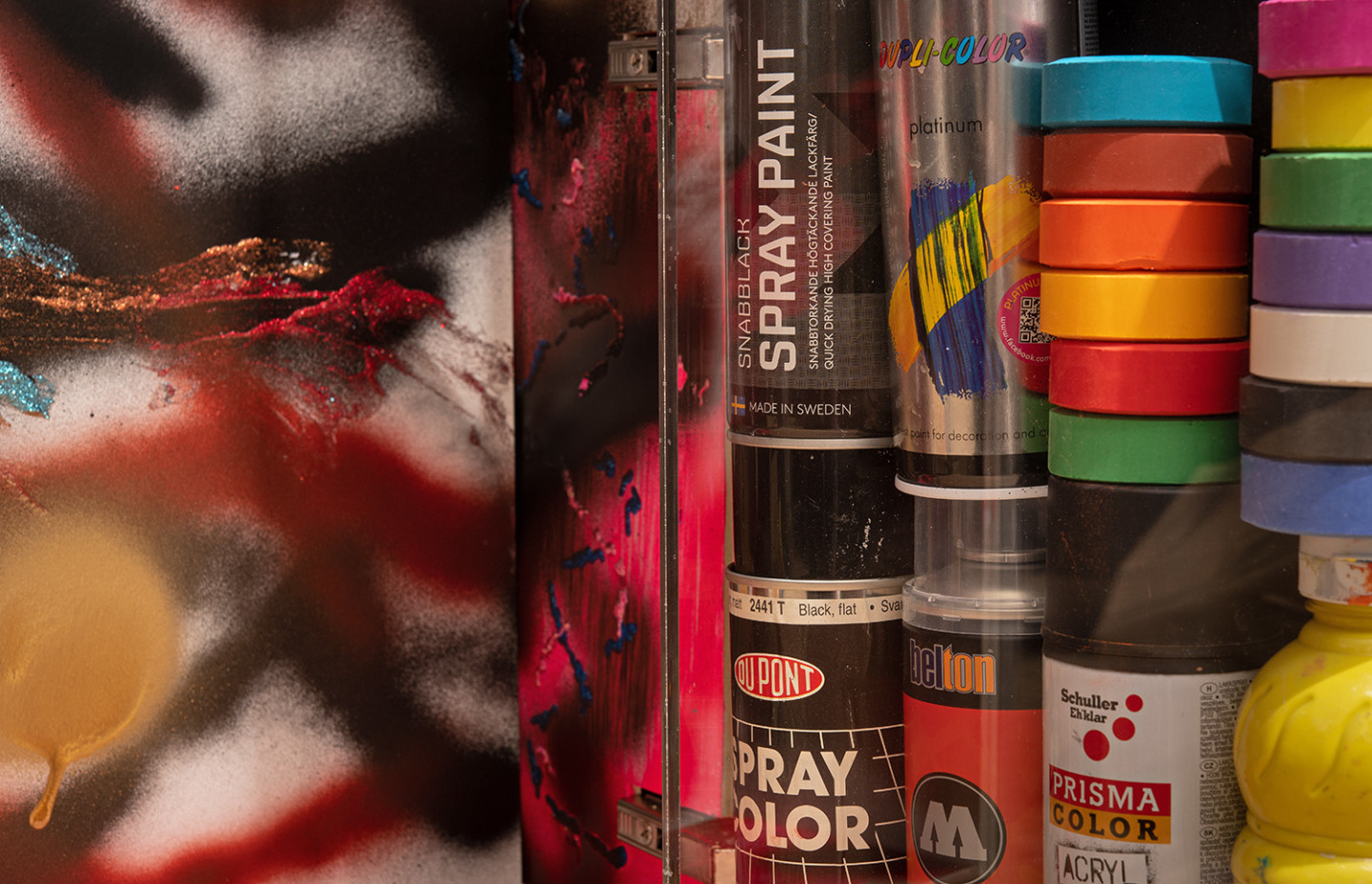 Stacks of cans of spray paint and lacquer paint.