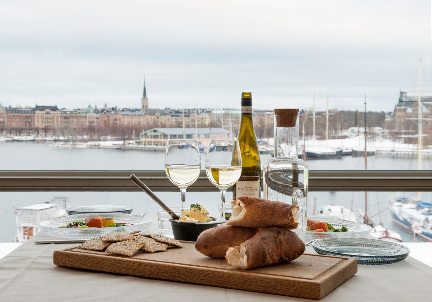  Wine glasses, bread and plates in front of the view from Moderna Museet's restaurant