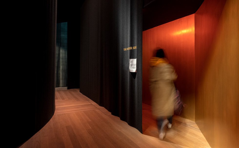 A person steps into one of the rooms in the exhibition "Nan Goldin – This Will Not End Well"