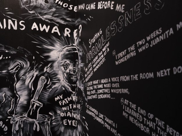 White paintings on a black wall