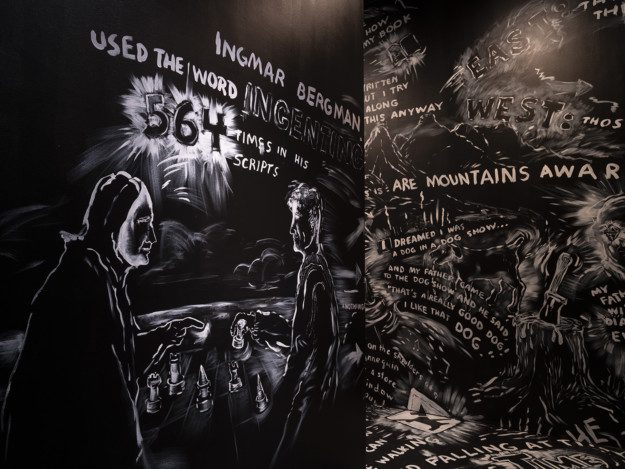 White paintings on a black wall