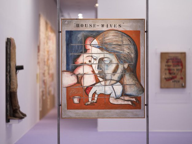The painting depicts a big head, a figure omn it's knees scrubbing the floor and a naked female body. Colorblocks in red, blue and beige. Over all figures is a grid.