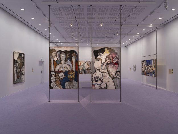 Installation view over the exhibition. Artworks are displayed on metal pipes. The room has purple walls and a purple carpet.