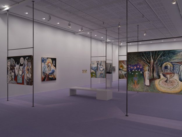 Installation view over the exhibition. Artworks are displayed on metal pipes. The room has purple walls and a purple carpet.