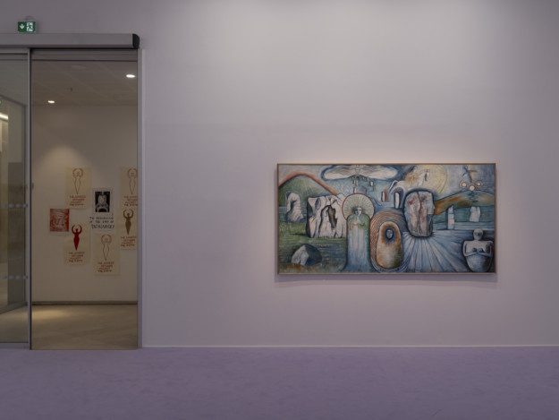 Photograph of part of the exhibition. On the left, a door, on the right, the painting "Meeting the Ancestors at Avebury"