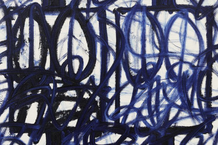 A close up photo of a white canvas with blue, dark blue and black patterns made with paint