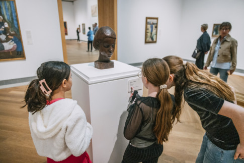 Personer tittar på skulpturen Flickhuvud