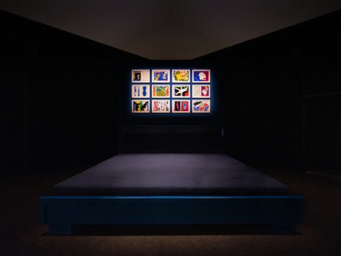 Installation view over the room "Jazz", a dark room with a big bed in the middle