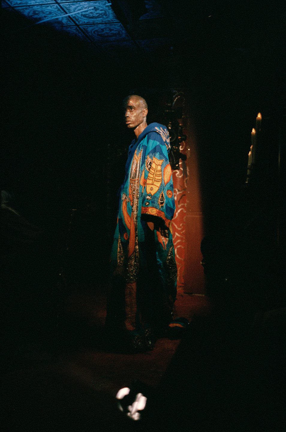 Photo from the film shoot, a person in a floor-long coat with hood