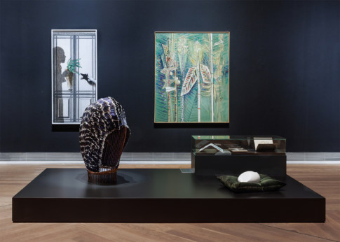 installation view with paintings and sculptures on floor