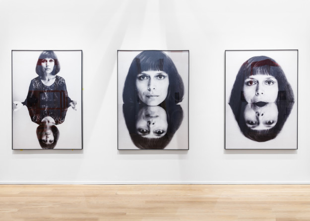 three photos of woman face on wall