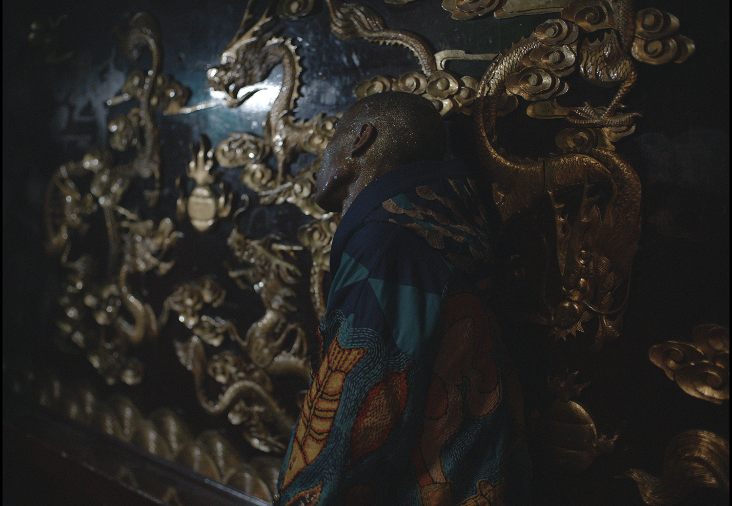person leaning against wall with dragons