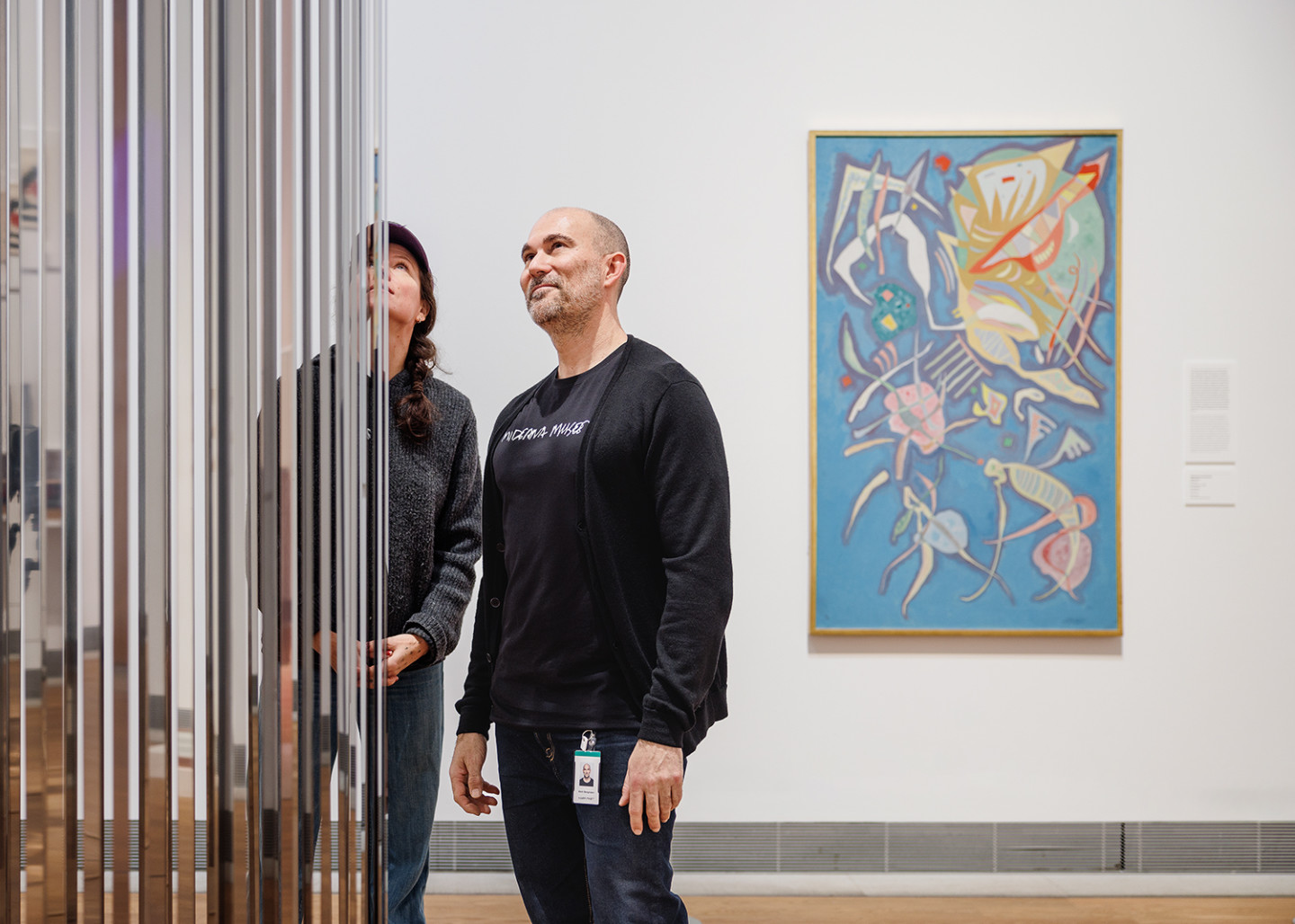  Two people looking at an artwork