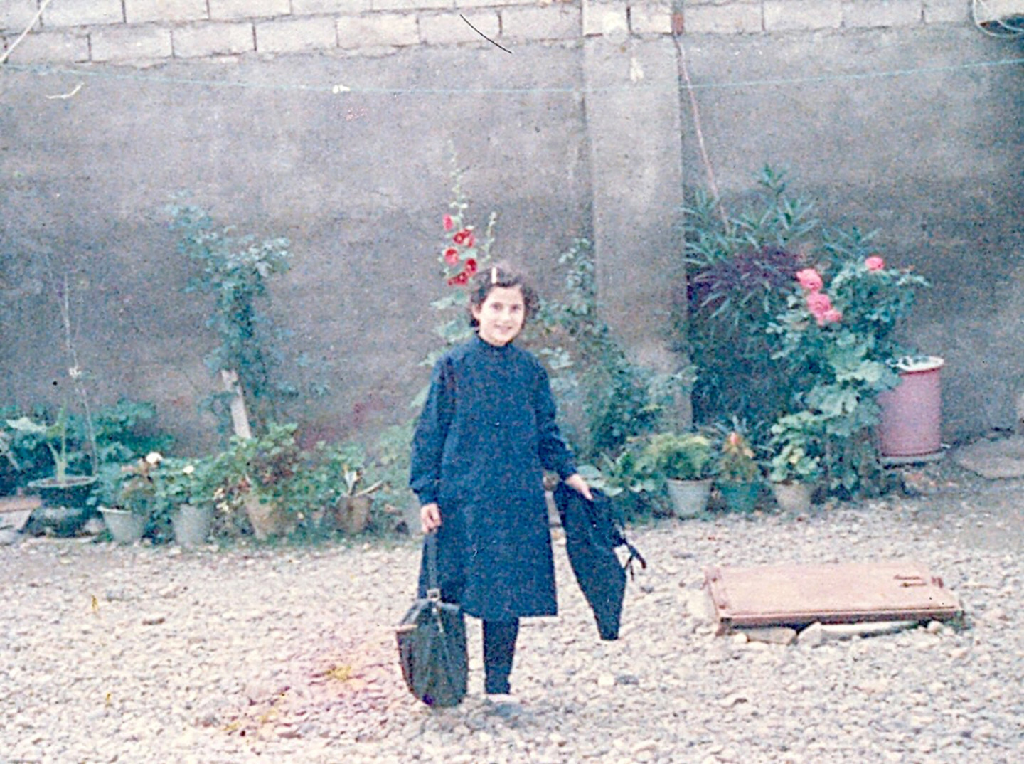 Photo of a girl standing with bags in her hands