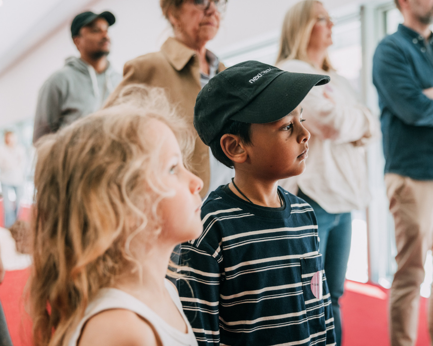 Two children are looking at art