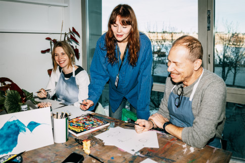 People creating in the workshop with an art educator
